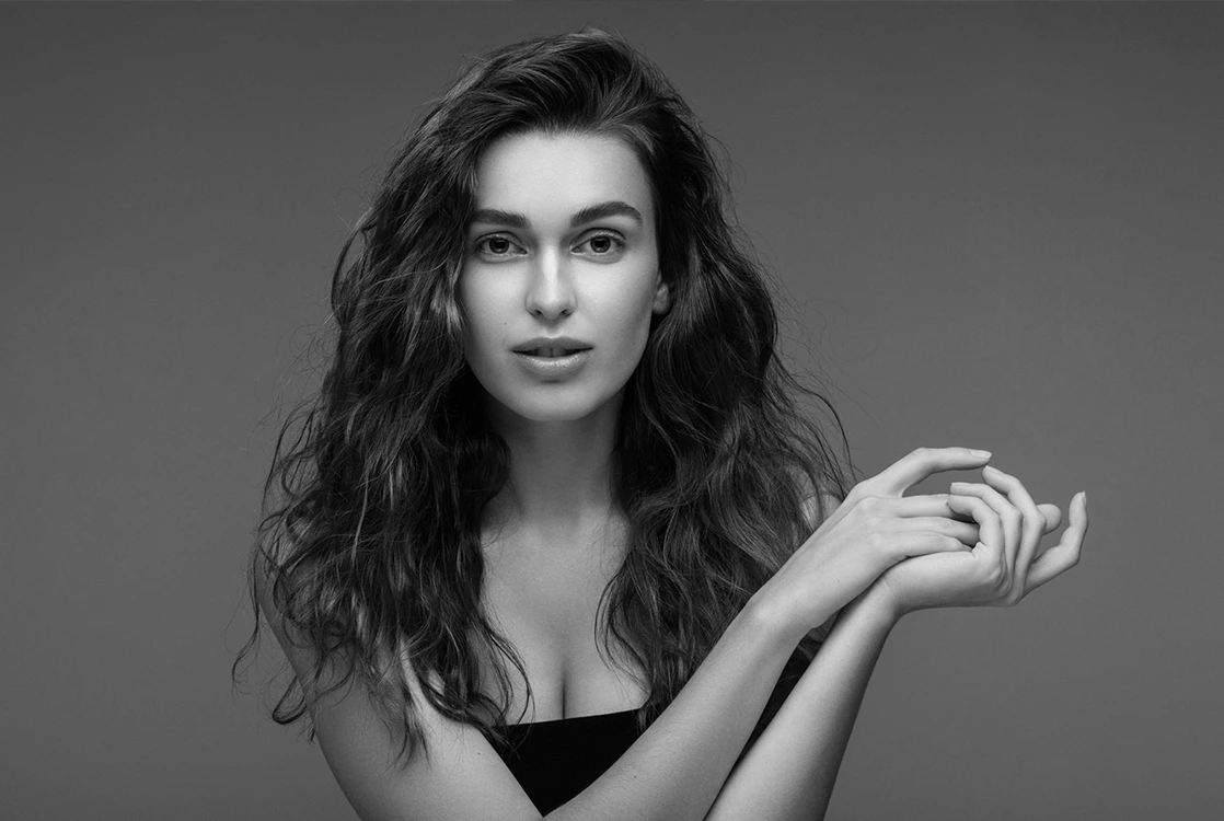 Facelift Surgery Expectation A black and white portrait of a woman with clear skin and a relaxed, youthful face results of facelift surgery.